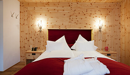 Bed in a Stone pine room in Minglers Sportalm in Kirchberg in the Kitzbühel Alps